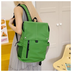 Side view of grass green high-capacity backpack with waterproof zipper and mesh side pocket