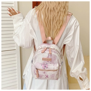 Detail of lavender tie-dye mini backpack with butterfly print and pink shoulder straps