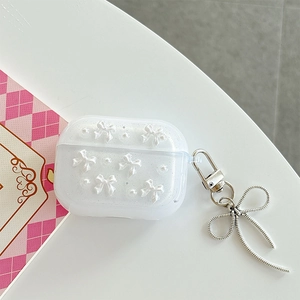 Detail of white glitter AirPods Pro case with 3D bows, pearls and silver metal charm