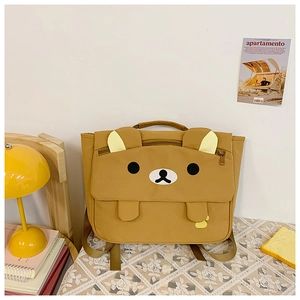 Detail view of brown bear backpack with 3D ears and embroidery on soft canvas fabric