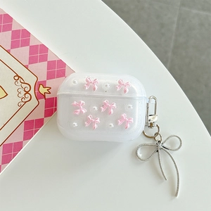 Detail of glitter AirPods Pro case featuring a 3D pink bow and pearl chain charm