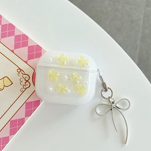 Detail of glitter AirPods Pro case with yellow bow, white pearls and silver metal hook