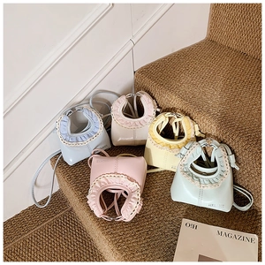Group of colorful mini bags with lace trim and leather straps on steps