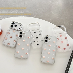 Transparent iPhone cases with 3D bows and pearls on a white decorative background