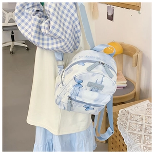 Side view of student canvas backpack featuring blue butterfly prints and ink art style