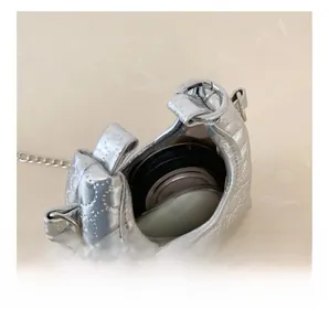 Internal view showing the storage capacity of the quilted silver mini crossbody bag