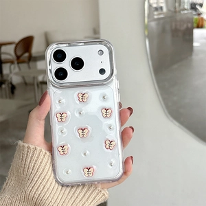 Detail of clear iPhone case featuring 3D silver bows and pearls on a hand-held phone