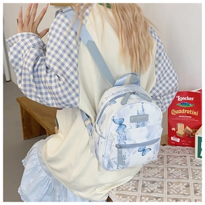 Detail of blue butterfly print and Chinese calligraphy on waterproof canvas backpack