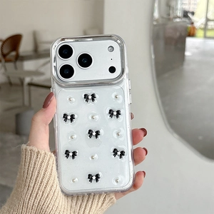 Detail of transparent iPhone case with 3D black bows, silver studs, and star accents