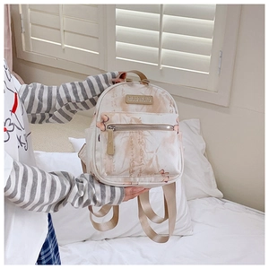 Detail view of canvas backpack with floral patterns and front zipper pocket