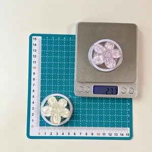 Detailed view of sequined flower phone socket size and weight measured on scale