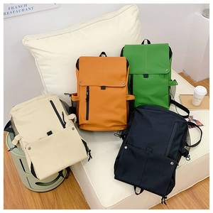 Detail view of large capacity backpacks in beige, orange, green and black colors