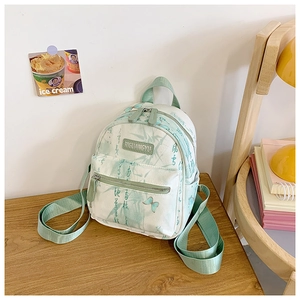 Detail of butterfly and bamboo calligraphy prints on light canvas kids backpack