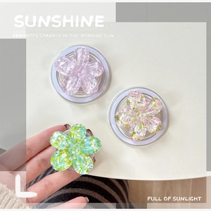 Close-up of glitter flower phone grips in pink and purple colors with acrylic texture