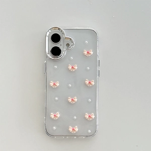 Macro shot of 3D pink bow and pearls on a clear iPhone case with silver camera ring