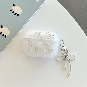 Detail of glitter AirPods Pro case featuring silver bow charms and woven pendant