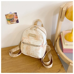 Detail of cream canvas backpack with traditional Chinese ink butterfly patterns and leather logo