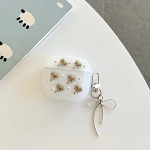 Detail of glitter AirPods case with silver hearts, pearls and bow pendant
