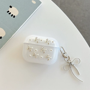 Detail of AirPods Pro case with silver bow pendant and pearlescent glitter finish