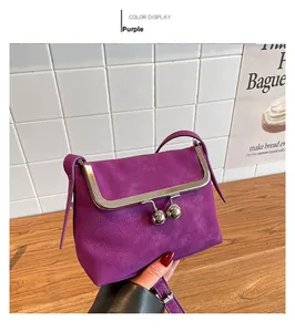Detail of purple crossbody bag with lychee texture and vintage metal ball lock