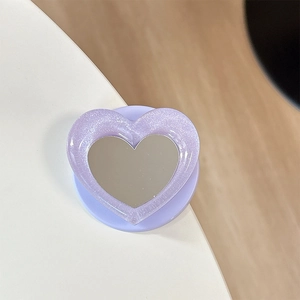 Detailed macro view of purple glitter heart phone grip with built-in makeup mirror