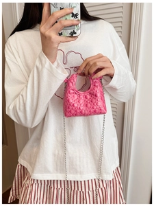 Pink mini crossbody bag with embossed diamond pattern and silver chain shoulder strap