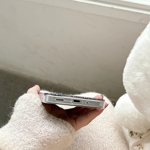 Close-up of clear glitter phone case with precise cutouts for charging port and speaker
