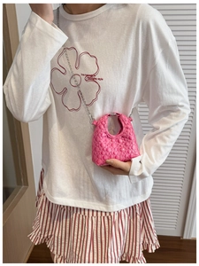 Mini pink bubble textured crossbody bag with silver chain strap shown on a child model