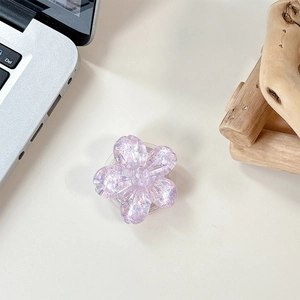 Detailed macro of a purple 3D flower phone socket with glitter in resin material