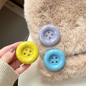 Poignées bouton pour téléphone tons pastel avec texture mouchetée noire sur fausse fourrure