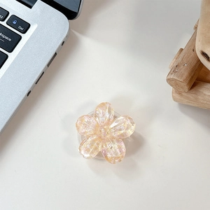 Close-up of pink flower phone socket with sparkling sequins and transparent base