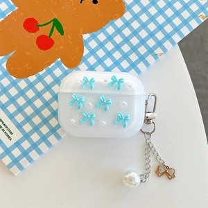 Detail of AirPods Pro case with blue bow pearl pendant on blue and white checkered background