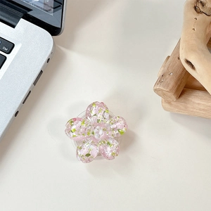 Macro shot of 3D pink resin cherry blossom phone socket with colorful glitter flakes