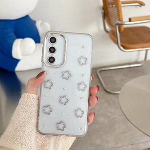 Detail of glittery blue Samsung case with silver hollow flowers and pearl accents