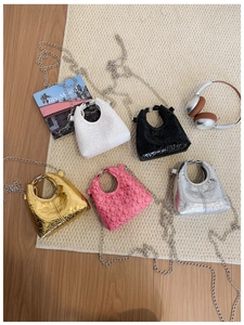 Detailed flat lay of quilted mini crossbody bags in five metallic colors with silver chains