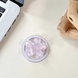 Detail of floral MagSafe phone grip with sparkling sequins and resin cherry blossom