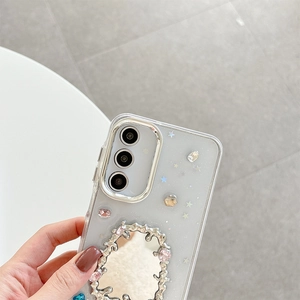 Detail of silver phone case with vintage mirror, rhinestones, and star patterns