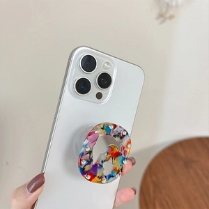 Detailed view of floral pattern phone grip with dolphin mirror and rhinestone accents