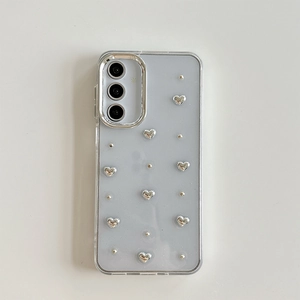 Close-up of silver hearts and metal dots on a sleek light grey floral Samsung phone case