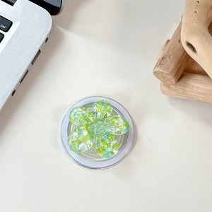 Macro shot of 3D sequin floral phone socket with green and yellow petal fragments