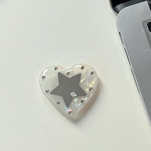 Macro shot of heart-shaped rhinestone phone grip with star design and iridescent texture
