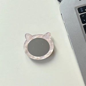 Cat ear phone grip with pearl white frame and integrated vanity mirror on white desk