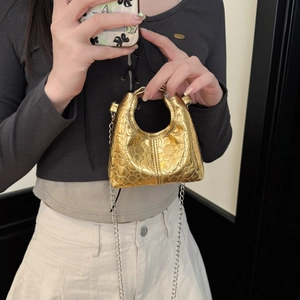Mini golden crossbody handbag for children featuring metal chain strap and quilted texture