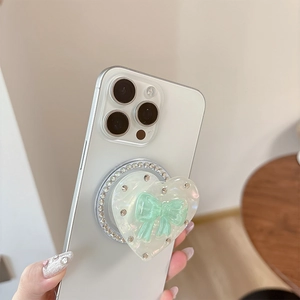 Detail of laser heart phone grip with mint green bow and sparkling rhinestones