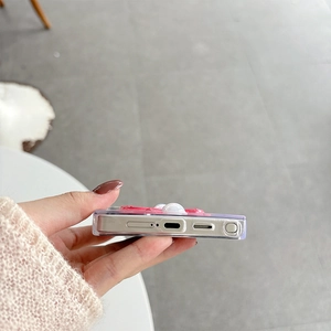 Detail shot of the precise bottom ports and floral pearl decor on a clear Samsung case