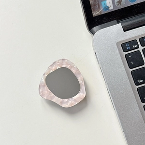 Macro shot of rhinestone dolphin mirror phone grip holder with iridescent pink pearly frame