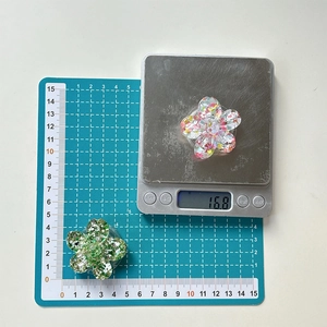 Detailed macro view of 3D glitter flower phone socket stand weighing 16.8 grams