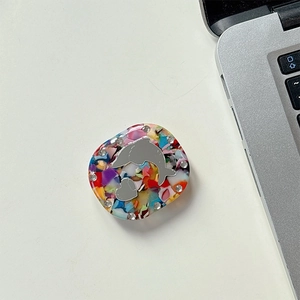 Macro detail of dolphin mirror phone grip with colorful stones and rhinestone trim
