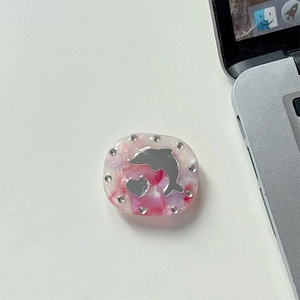 Detail view of rhinestone phone grip with dolphin mirror and pink pearlescent finish