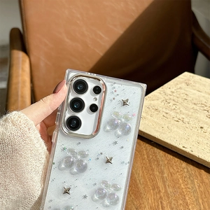 Detailed view of clear glitter Samsung case with 3D cherry and metallic star charms